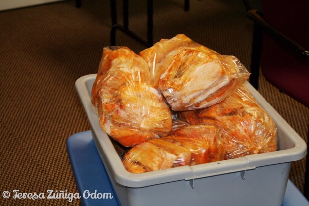 Pork tamales wait their turn to get saran wrapped and foil wrapped for pick up.