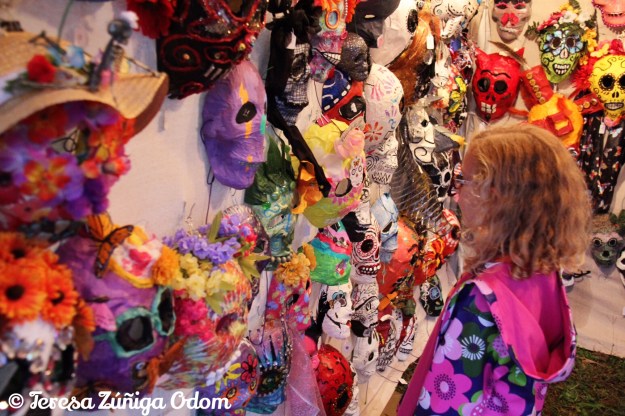 A little girl admires the sugar skull masks at Dia de los Muertos Birmingham Festival 2015